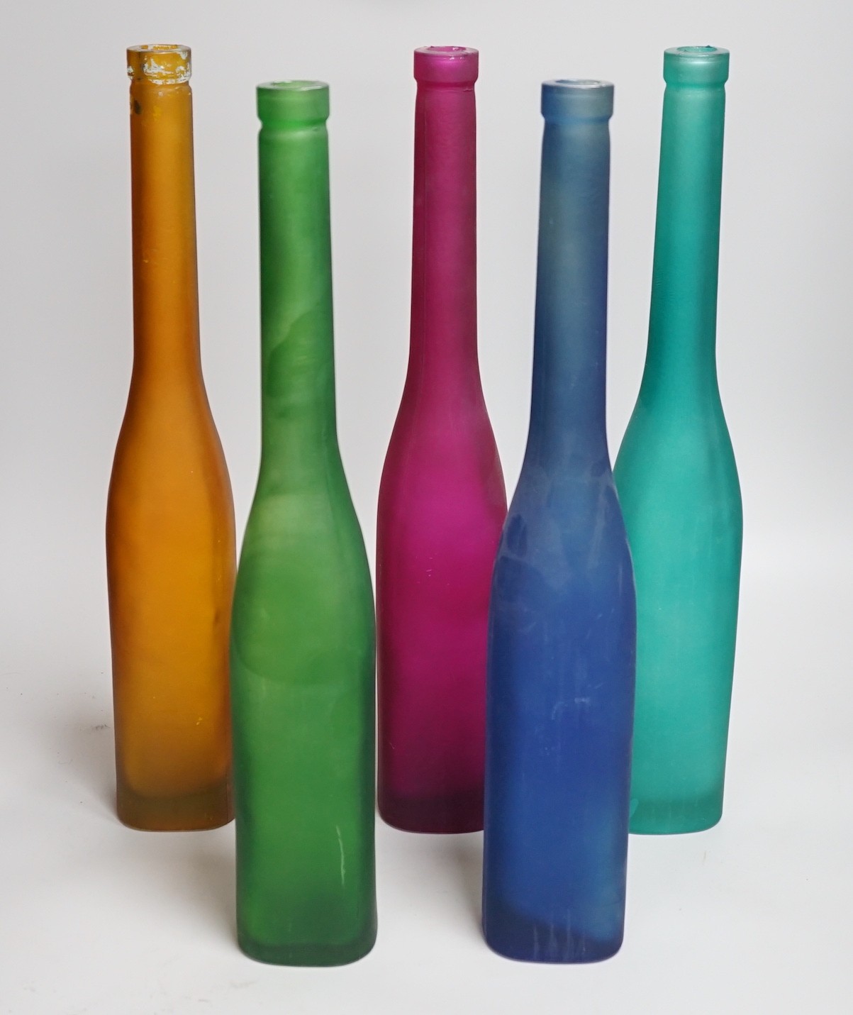 Five coloured glass bottle-neck vases, 42cms high